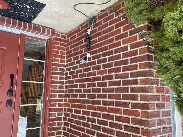 The entry recess in 2020, the same corner the applicator worked in 2003, red brick running from the door surround to the outside corner in one range