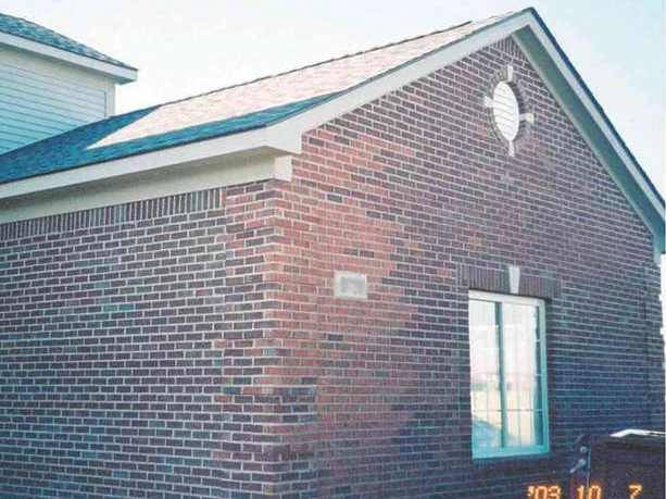 The gable end in 2003, a pale washed out patch running down the brick beside the round louvre vent and across the corner pier, with a camera date of October 7 burned into the frame