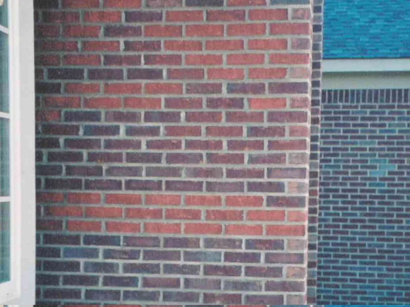 The pier beside a bay window in 2003, its face a pale mottled red against the darker brick of the return wall to the right
