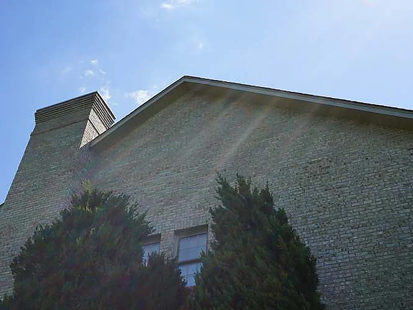 The same gable end in 2019 seen from below, the brick still one even tone up to the chimney