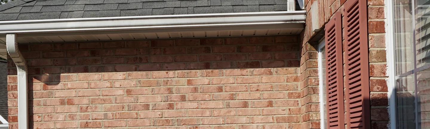 The side wall of the Shiloh house in 2019, its brick one even light red and tan range under a deep eaves overhang