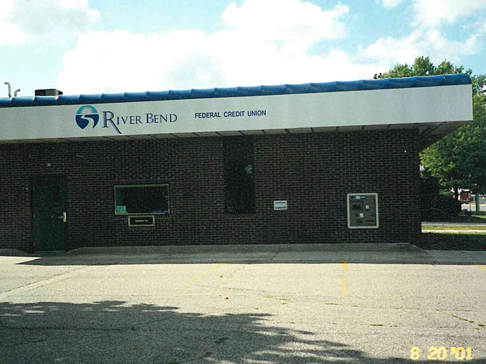 The bank's front elevation in 2001 under its blue barrel canopy, the brick reading as one dark red brown across the wall