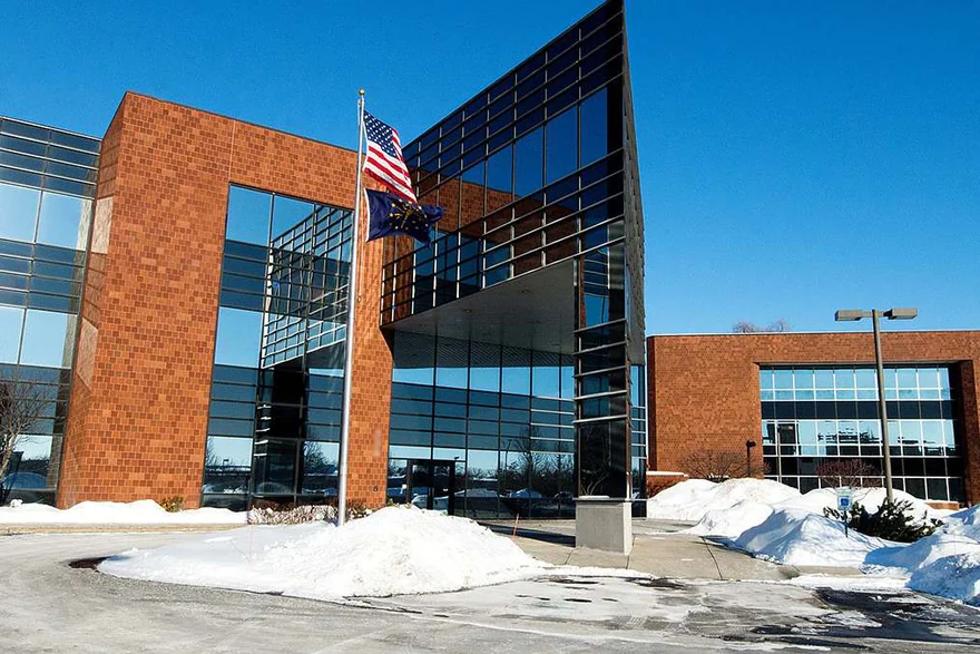 A South Bend office in 2014, brick and glass wings around the entrance, the 2002 addition reading as the same brick as the original building