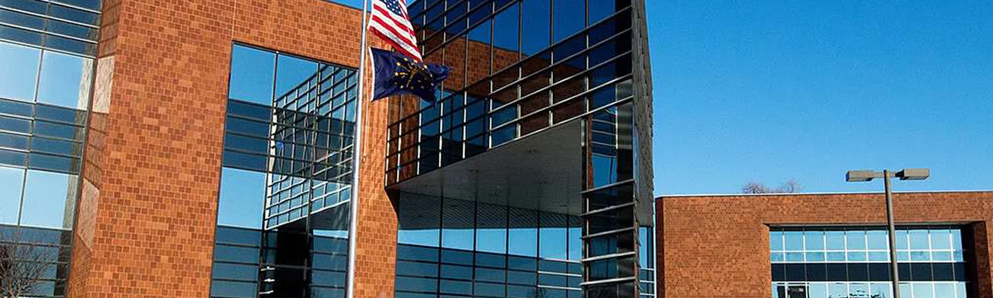 The 2002 addition and the 1950 building side by side in 2014, the brick on both reading as one wall