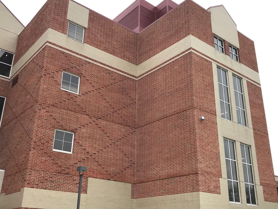 The corner of the South Bend high school in 2019, three storeys of red brick banded with buff