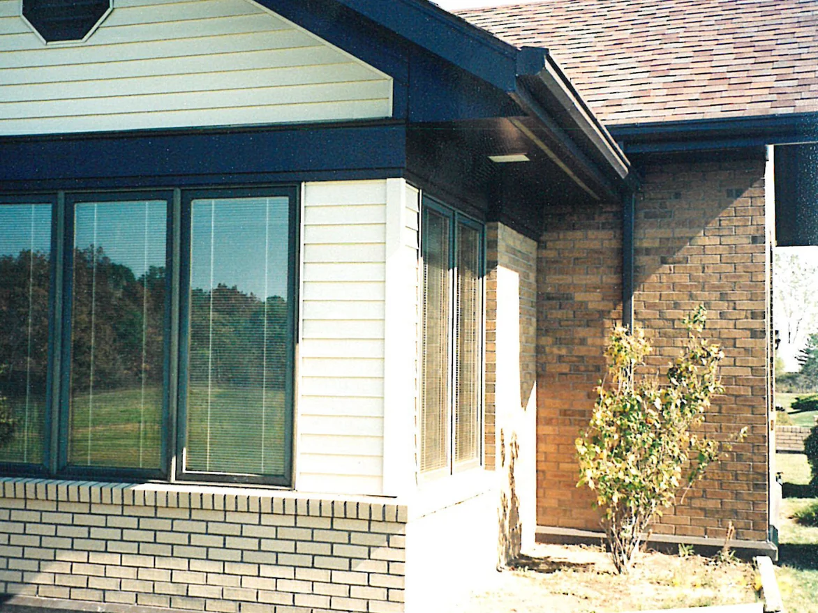 The glazed front bay in 1998, the low wall under its windows built in pale cream brick against the tan brick of the house beside it