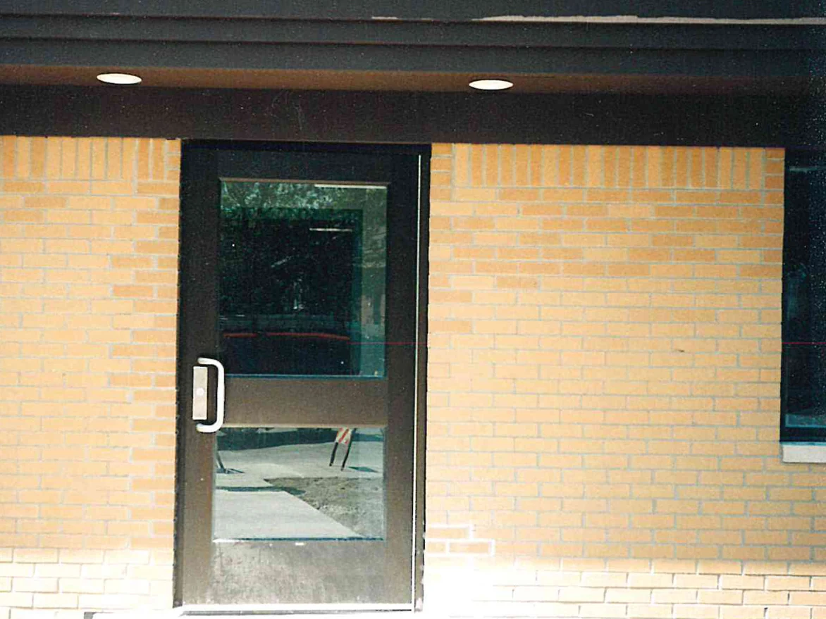 The station's entrance door in 1998, the brick to the right of it a deeper orange than the paler buff brick on the left