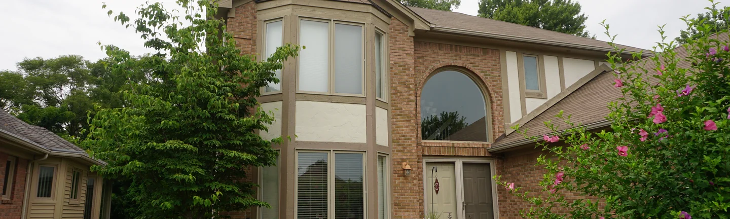 The Sterling Heights home in 2019, its brick one warm tan blend across the bay window and the entry