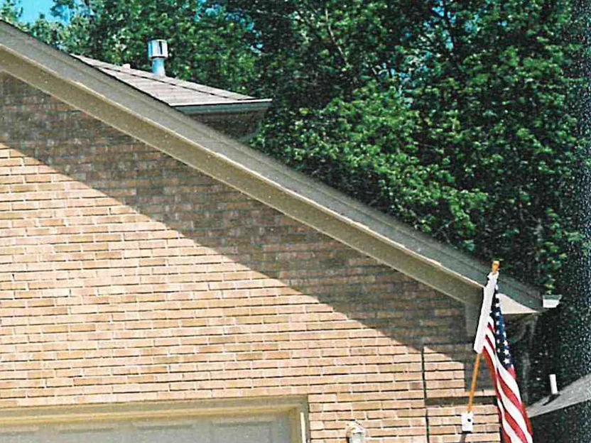 The garage gable after the 2003 work, its brick an even light tan running the full rake of the eave