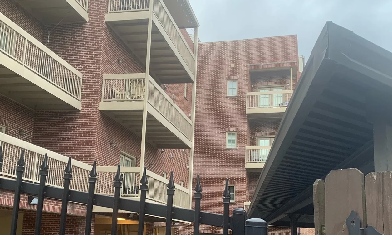 Balconies at The Row, a four-story apartment block in Tennessee, in 2021, its brick one range seventeen years after staining