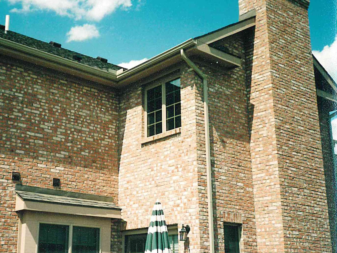The rear corner and the full height of the chimney during the 1998 work, the chimney and the wall beside it warmer and pinker than the wall to the left