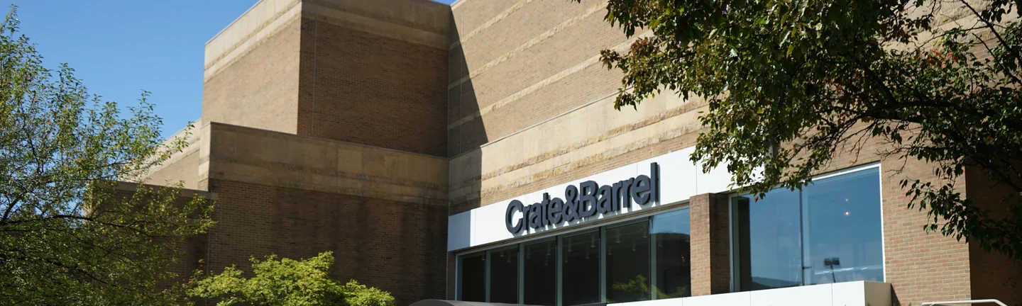The mall in 2019 behind its lawn, a tan brick mass stepping up over a Crate & Barrel storefront