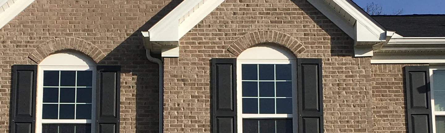 The two front gables of the Uniontown home in 2020, the brick in the upper peak reading as one run with the wall below it