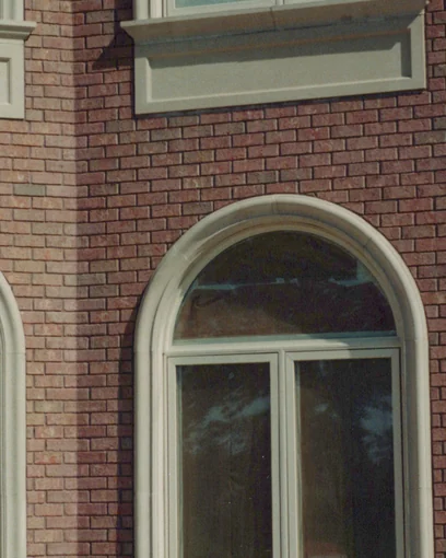 Arched windows and a brick corner in Warren, Ohio in 1999, the shaped corner units matching the red wall after staining