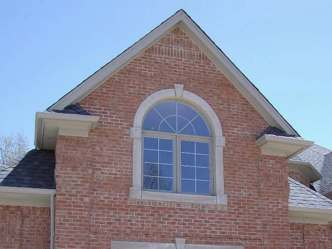 A gable with an arched window in 2007, the brick pale pink with darker units showing through it