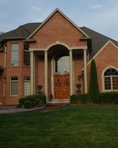 A brick home in Washington, Michigan in 2019, the blend reading as one wall twelve years after staining