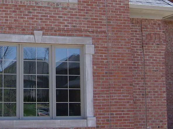 The same side wall window in 2019, the brick around the stone trim one even red range to the corner