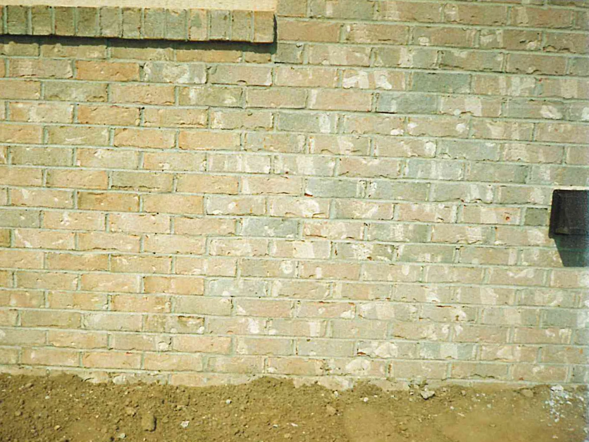 Brick at unit scale in 1996 with the work finished, cream, tan and grey units in one range above bare ground