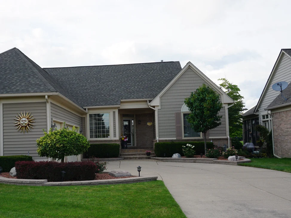 The front of a single-story home in Washington, Michigan in 2019, brick and siding under a low grey roof