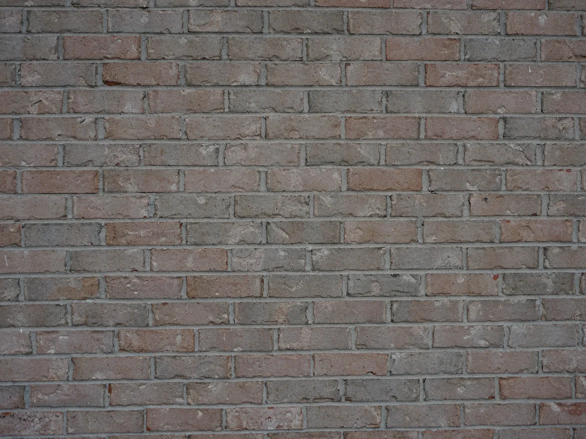 A full frame of the wall at unit scale in 2019, tan, cream and grey units in one range with pale mortar joints