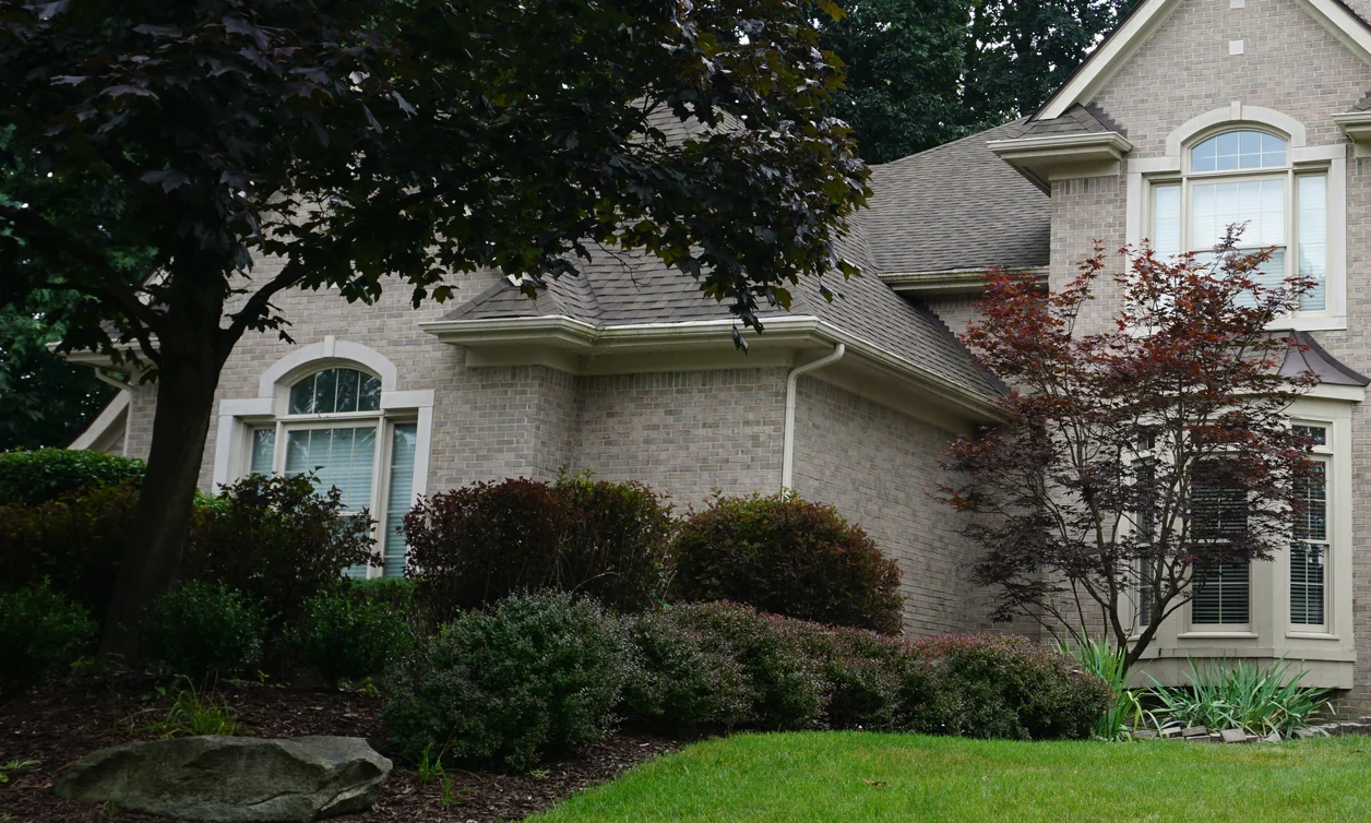 A two-story house in West Bloomfield, Michigan in 2019, its light brick even twenty years after the blotchy blend was corrected
