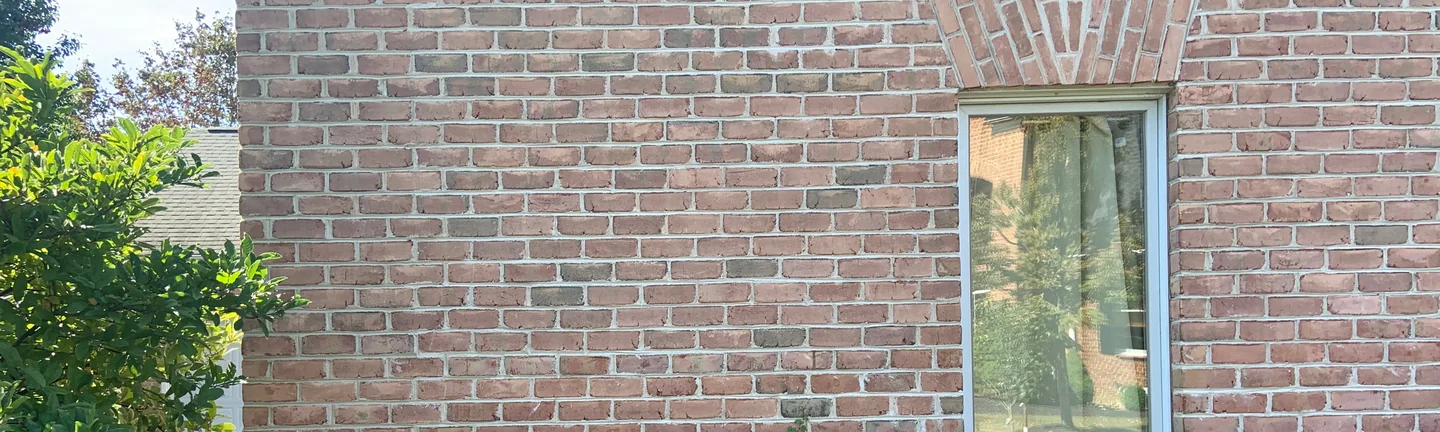 The brick wing of the Westerville house in 2019, its brick reading as one even red and tan range