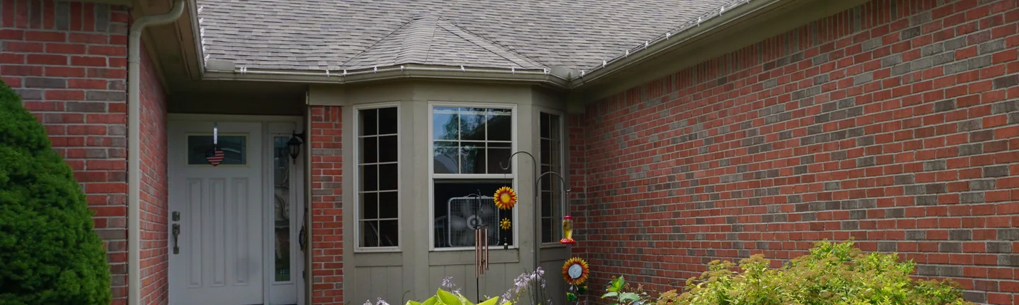 The brick front entry of a White Lake, Michigan house in 2019, its reds, greys and tans sitting in one range