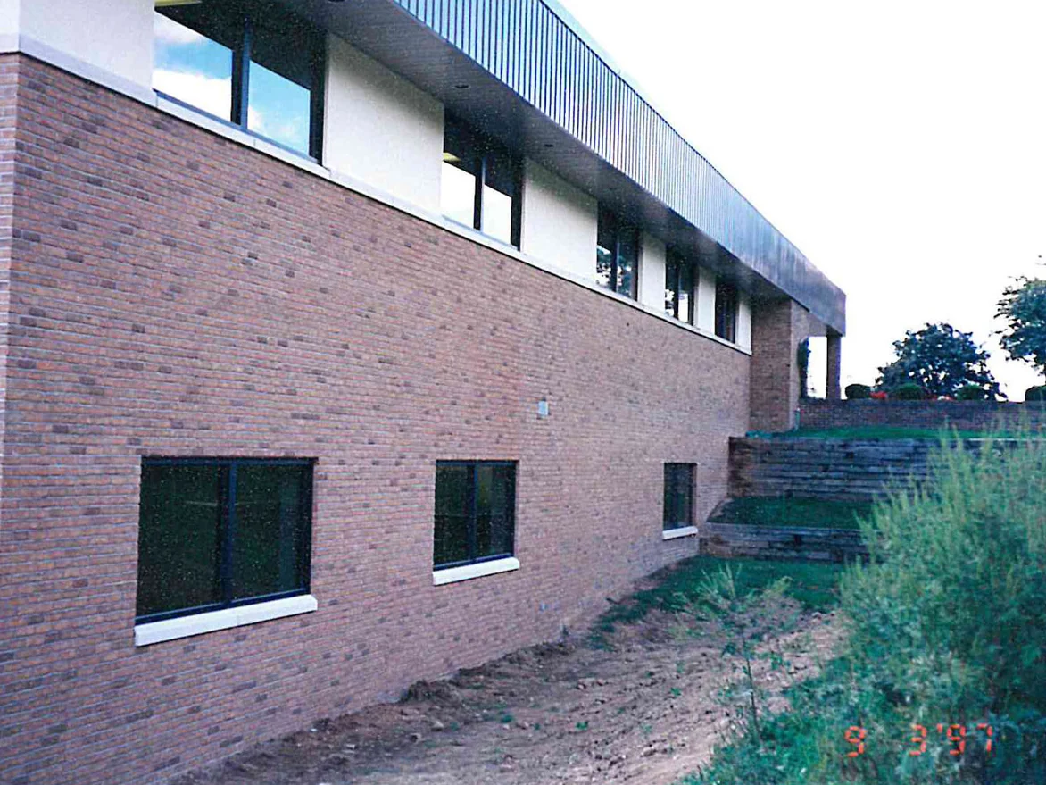The same wall later in 1997 from further along, the brick now reading warm red brown with darker units scattered through the courses and the mortar carrying the same tone