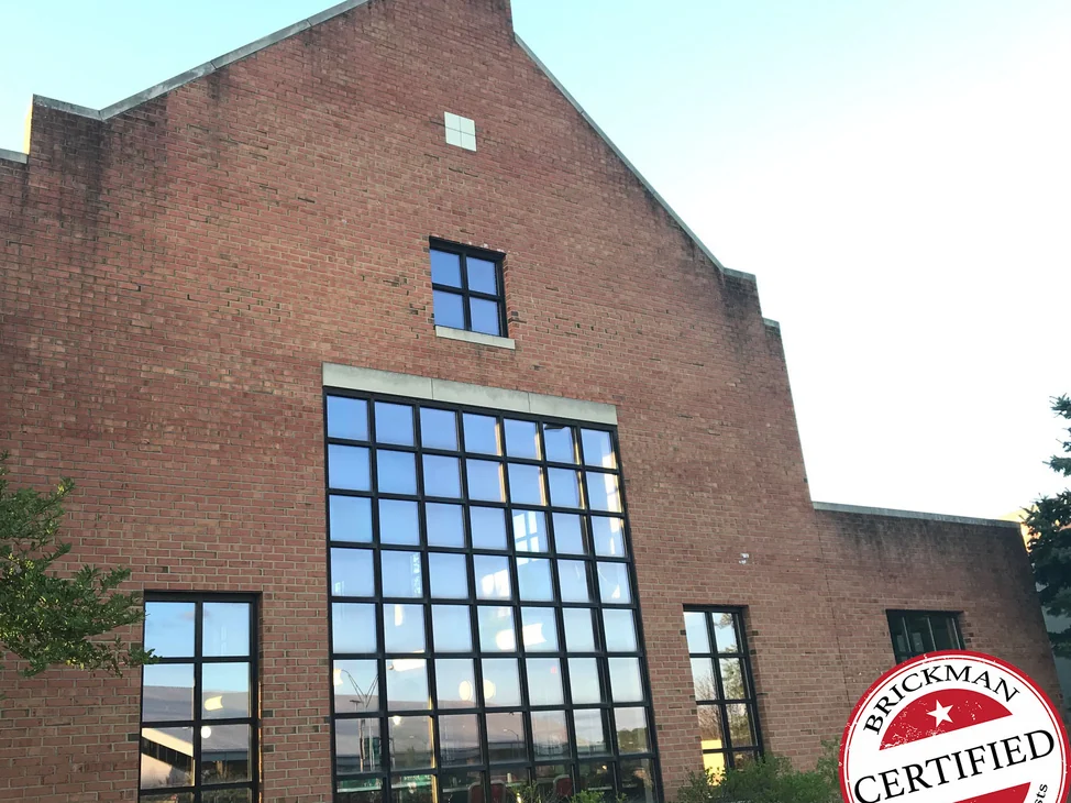 The gable end of the Youngstown State building in 2019, its brick reading as one even red across the whole wall